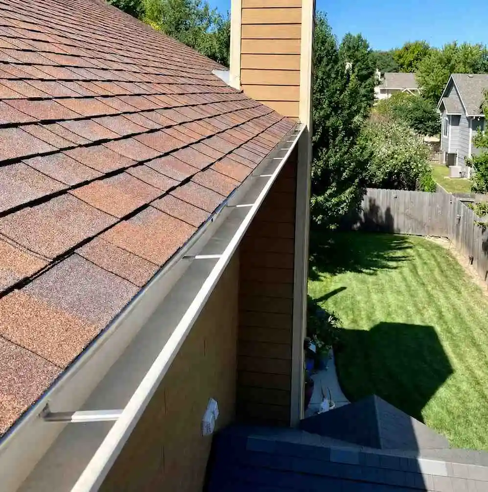 New rain gutter replacing an old damaged gutter system